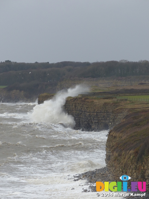 LZ00667 Waves crashing against cliffs at Llantwit Major beach